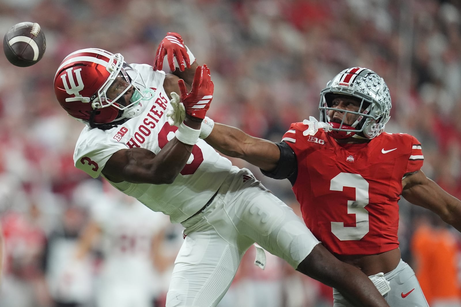 Ohio State's Lorenzo Styles Jr. breaks up a pass intended for Indiana's Omar Cooper Jr. during the first half of the Big Ten championship NCAA college football game in Indianapolis, Saturday, Dec. 6, 2025. (AP Photo/Michael Conroy)