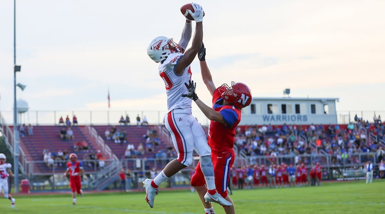 Stebbins High School junior Adrian Norton leaps over Northwestern's Austin Ernst to catch a touchdown pass during their game on Thursday, Aug. 19 at Taylor Field in Springfield. The Indians won 55-14. CONTRIBUTED PHOTO BY MICHAEL COOPER