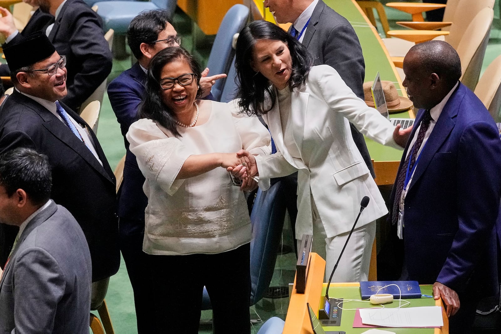 Annalena Baerbock of Germany, second from right, talks with delegates in the United Nations General Assembly, Monday, June 2, 2025. (AP Photo/Richard Drew)