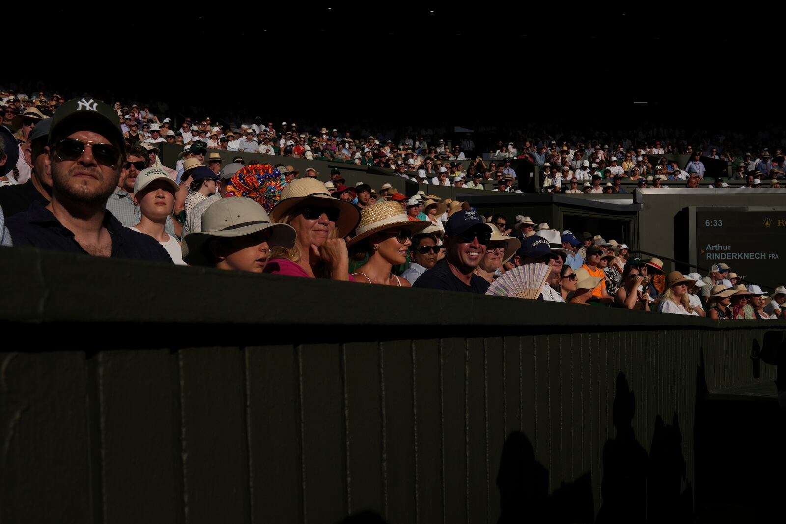 Spectators watch as Alexander Zverev of Germany plays Arthur Rinderknech of France during their first round men's singles match at the Wimbledon Tennis Championships in London, Tuesday, July 1, 2025. (AP Photo/Kin Cheung)