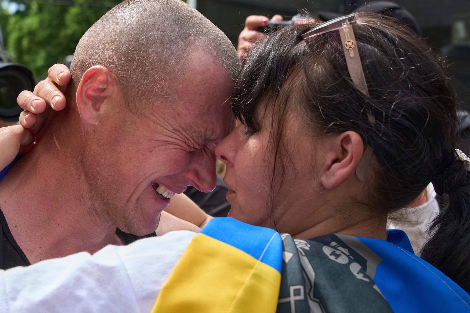 A Ukrainian serviceman Vitaly, hugs his wife Olena, after returning from captivity during a POWs exchange between Russia and Ukraine, in Chernyhiv region, Ukraine, Sunday, May 25, 2025. (AP Photo/Efrem Lukatsky)