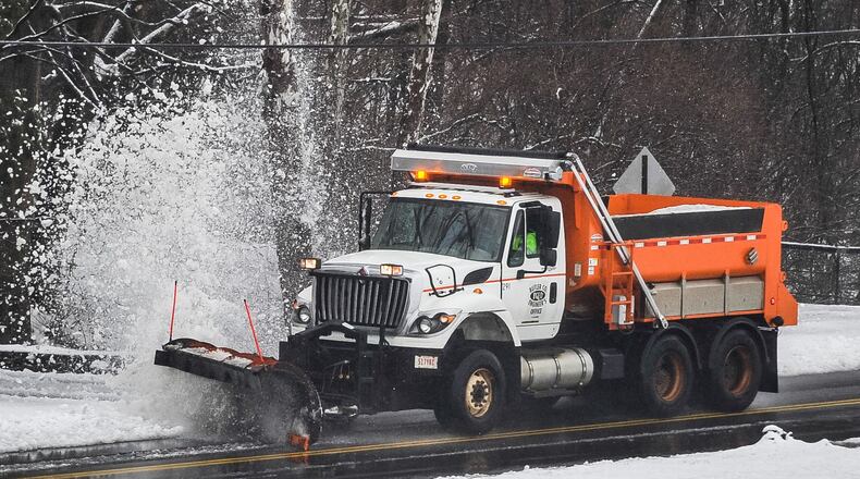 A snow plow from the Butler County Engineer’s Office blasts snow into the air on Elk Creek Road Wednesday, Feb. 20 in Madison Township. NICK GRAHAM/STAFF