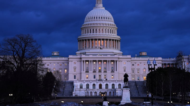 The U .S. Capitol is seen after sunset in Washington, Monday, Feb. 23, 2026, ahead of President Donald Trump's State of the Union address. (AP Photo/Matt Rourke)