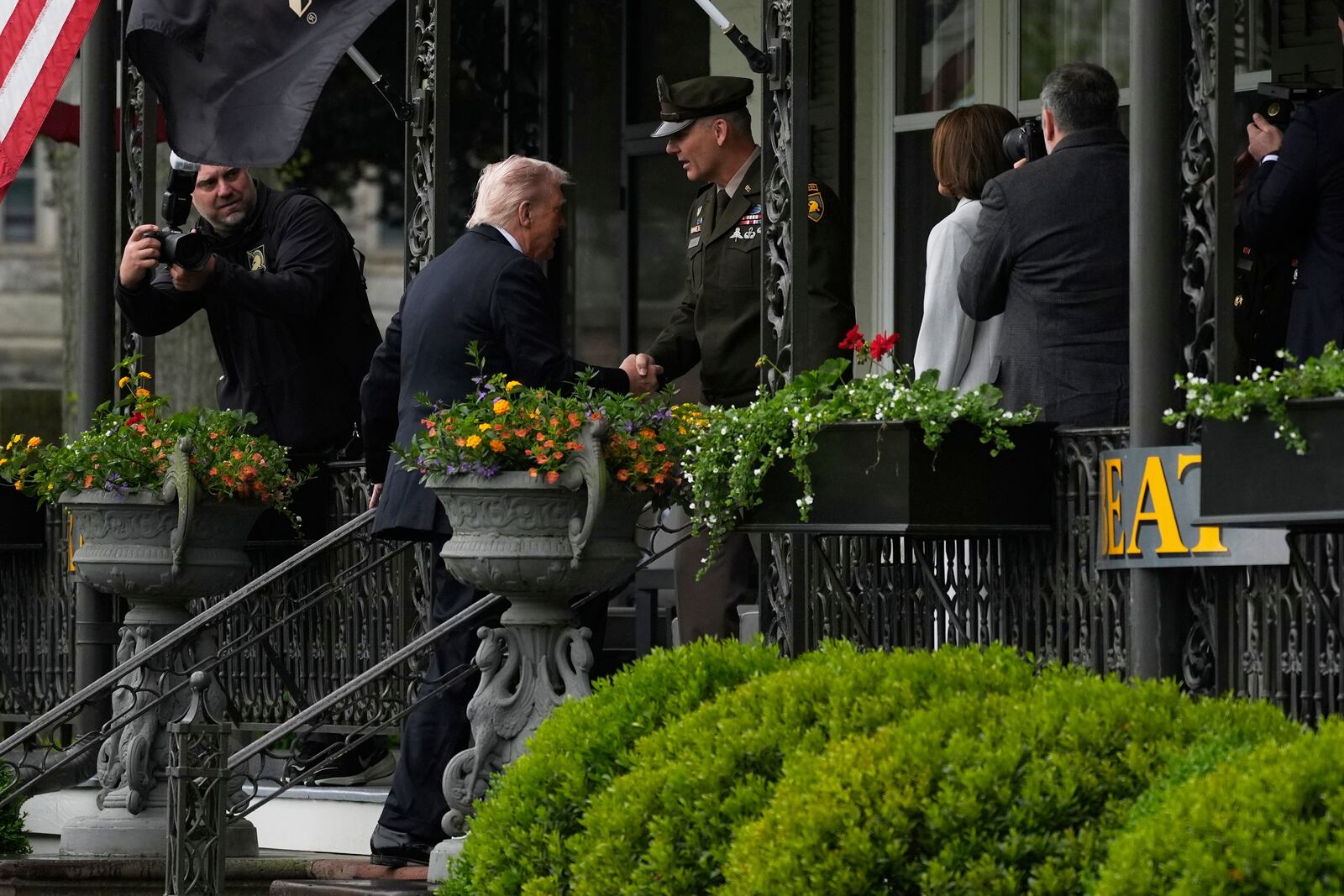 President Donald Trump, second left, is greeted as he arrives before delivering the commencement speech at the United States Military Academy commencement ceremonies in West Point, N.Y., Saturday, May 24, 2025. (AP Photo/Manuel Balce Ceneta)