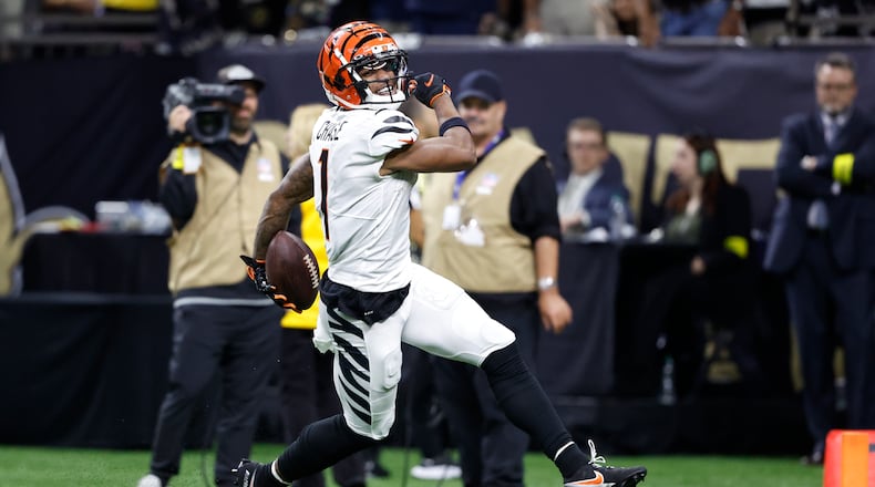 Cincinnati Bengals wide receiver Ja'Marr Chase (1) smiles as he runs for a touchdown against the New Orleans Saints during the second half of an NFL football game in New Orleans, Sunday, Oct. 16, 2022. (AP Photo/Butch Dill)