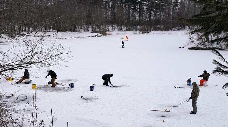 Ice fishermen take advantage of the cold weather as they fish on Shadow Lake, Friday, Jan. 29, 2021, in Solon, Ohio. (AP Photo/Tony Dejak)