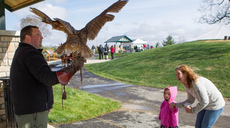 Harold Huffman’s great-great-niece Parker Guckenberger and her mom, Heidi, visit with Icarus the Owl and Shawn Connor of Heuston Woods during the 2012 dedication of Huffman Park in Fairfield. The city is hiring for a new parks director. STAFF FILE PHOTO