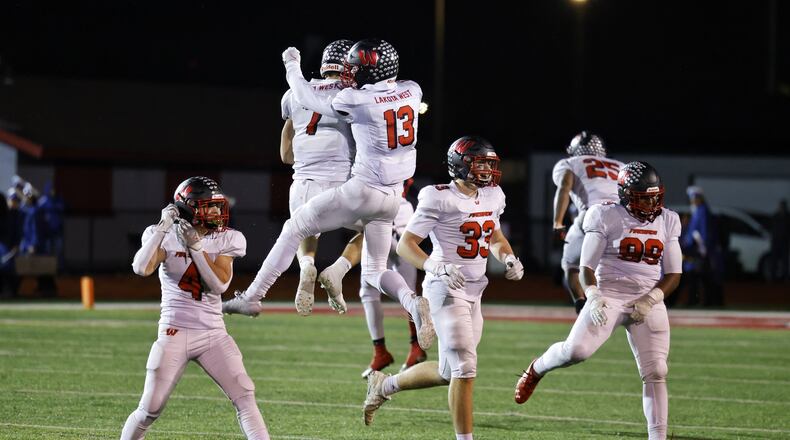 Lakota West quarterback Mitch Bolden (7) andcreceiver Ben Minich (13) jump to celebrate their Division I regional semifinal football playoff game victory against St. Xavier Friday, Nov. 12, 2021 at Princeton High School's Pat Mancuso Field. Lakota West won 12-2. NICK GRAHAM / STAFF