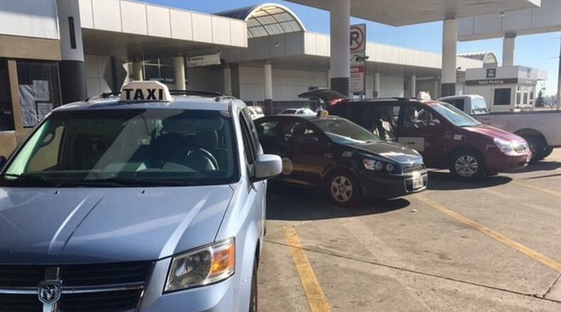 Taxis park in the queing area of the Dayton International Airport. (Caroline Reinwald/Staff)