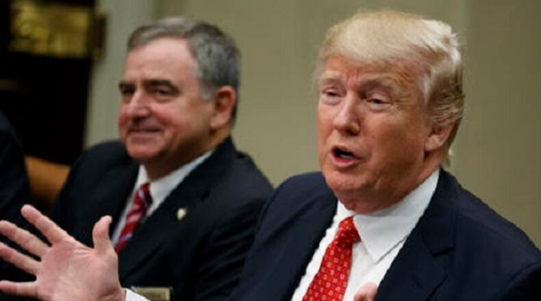 St. Charles, La. Parish Sheriff Greg Champagne, the president of the National Sheriffs Association listens at left as President Donald Trump speaks during a meeting with county sheriffs in the Roosevelt Room of the White House in Washington, Tuesday, Feb. 7, 2017. (AP Photo/Evan Vucci)