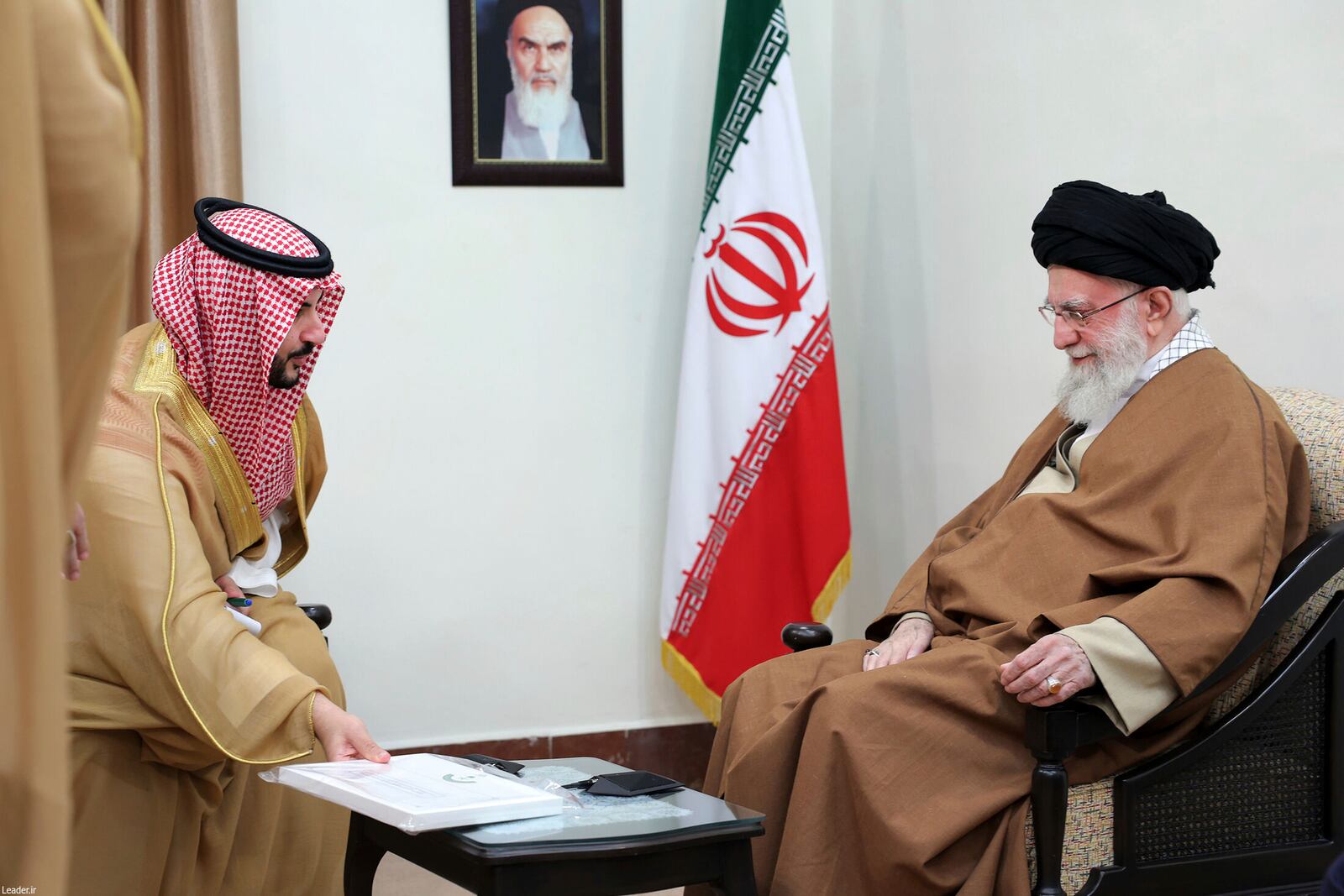 In this photo released by the official website of the office of the Iranian supreme leader, Saudi Arabia's Defense Minister Prince Khalid bin Salman, left, presents the message of the Saudi Arabia's king to the Supreme Leader Ayatollah Ali Khamenei during their meeting in Tehran, Iran, Thursday, April 17, 2025. (Office of the Iranian Supreme Leader via AP)