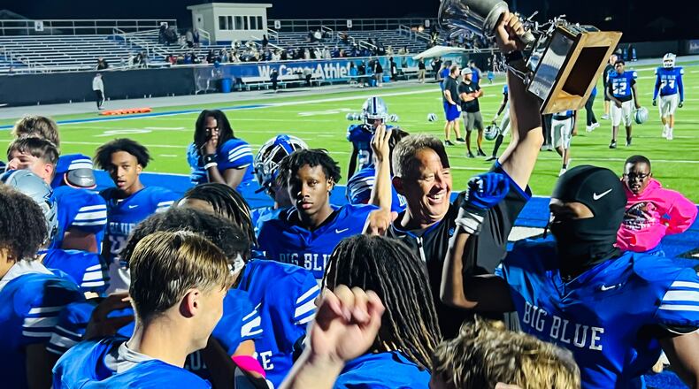 Hamilton coach Arvie Crouch and the Big Blue football team celebrate after their win against Middletown in the Butler Bowl on Friday night at Virgil Schwarm Stadium. Chris Vogt/CONTRIBUTED