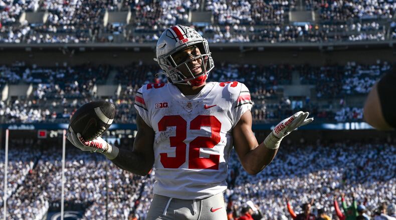 Ohio State running back TreVeyon Henderson (32) celebrates after scoring a touchdown against Penn State during the fourth quarter of an NCAA college football game, Saturday, Oct. 29, 2022, in State College, Pa. Ohio State won 44-31. (AP Photo/Barry Reeger)