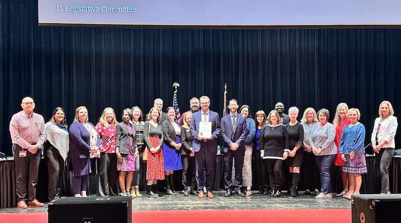 There are nearly 1,000 municipalities in Ohio and fewer than 4% of them win top honors annually from the state auditor for top-rated financial operations. Lakota Schools’ treasurer department recently learned its latest financial review by the Ohio Auditor’s Office was one of those winners this year. Lakota officials honored district Treasurer Adam Zink (center front with award) and his staff at last week’s school board meeting. (Provided Photo\Journal-News)