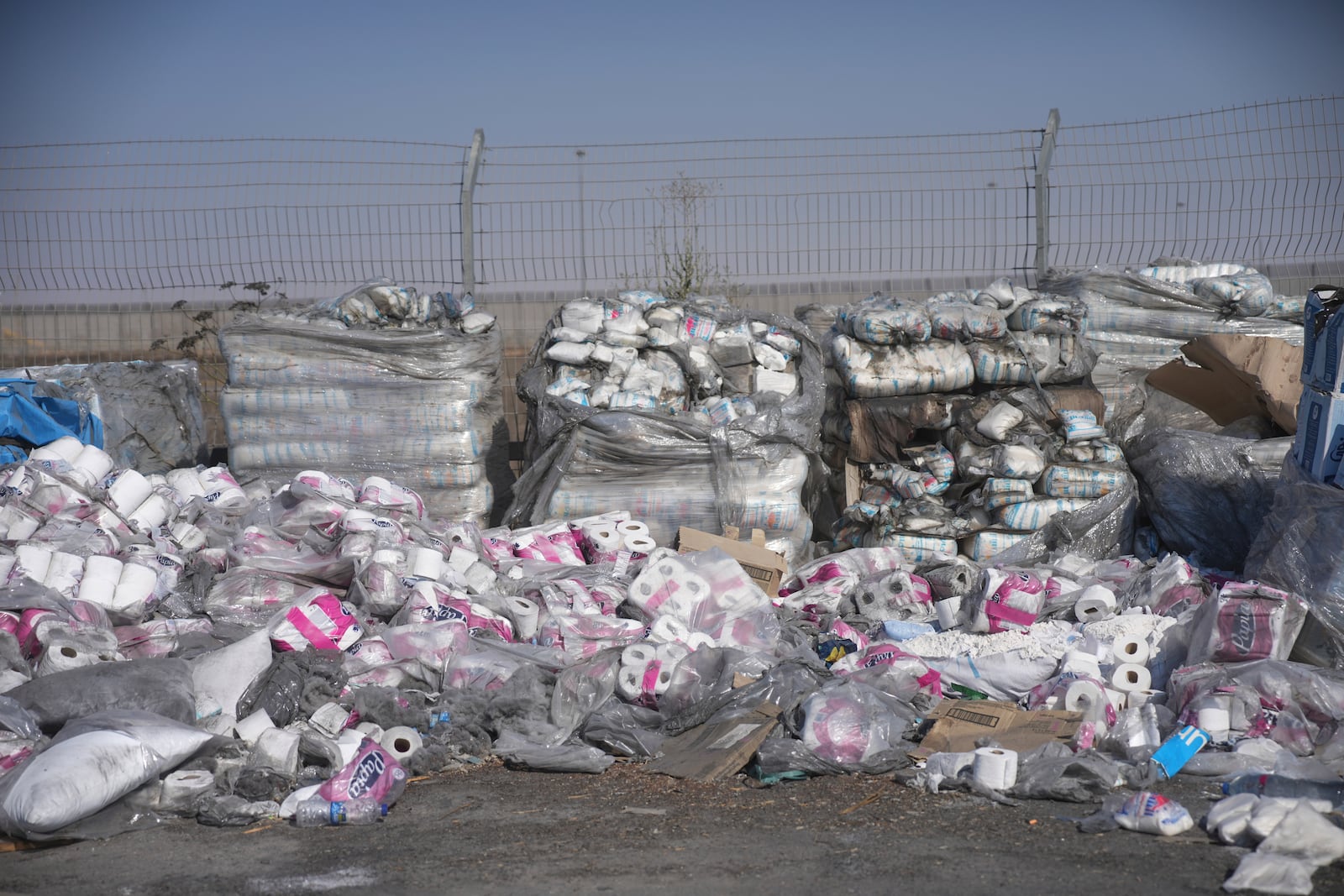 FILE - Piles of humanitarian aid packages wait to be picked up on the Palestinian side of the Kerem Shalom crossing in the Gaza Strip, Thursday, July 24, 2025, during a media tour organized by the Israeli army. (AP Photo/Ohad Zwigenberg, file)