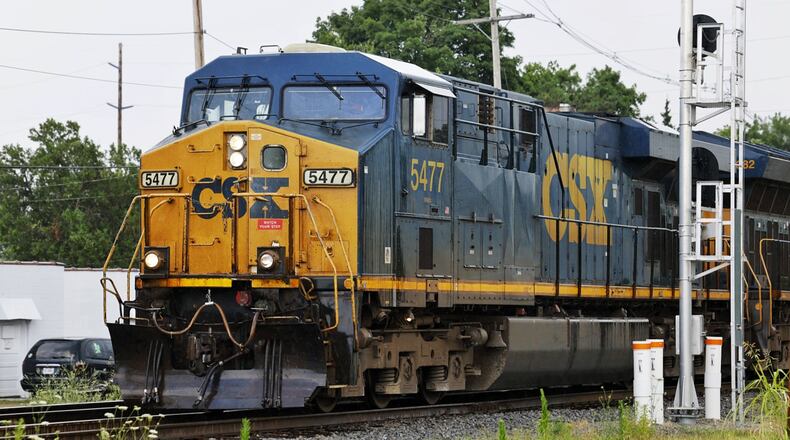 A CSX train travels along the railroad tracks crossing Laurel Avenue Tuesday, July 5, 2022 in Hamilton. Hamilton officials had a meeting last week with CSX officials. The train officials said they would work with city leaders the best they could, but there is not much they can do about blocking railroad crossing. They did recommend motorists to call a toll-free number that's posted at every crossing if there are problems, including stopped trains. NICK GRAHAM/STAFF