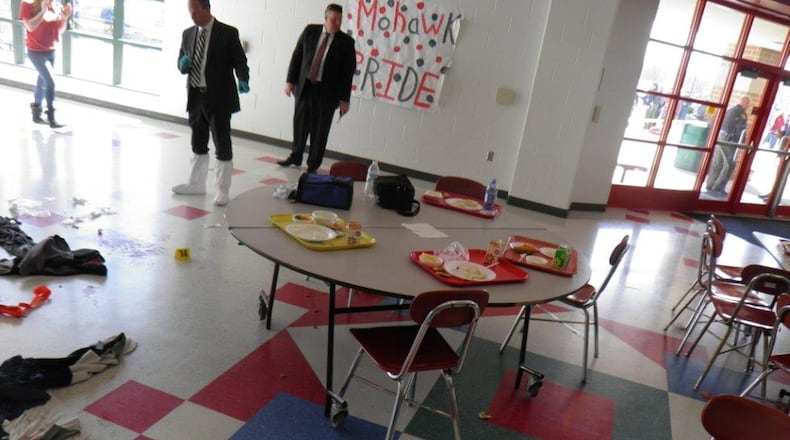 Police investigators look over the aftermath of the 2016 Madison High School shooting that left two students wounded and left the rural Butler County community in shock.