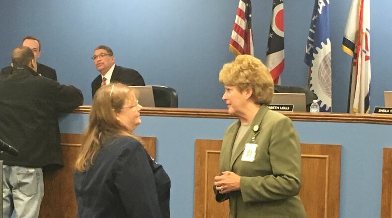 Dayton Public Schools Superintendent Elizabeth Lolli (right) talks to DPS Human Resources Director Judith Spurlock at a March 2018 school board meeting. The district is making significant changes to administrative staff this fall. JEREMY P. KELLEY / STAFF