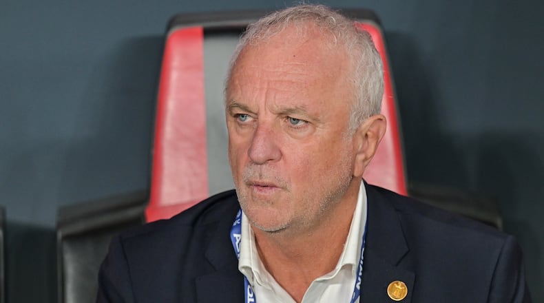 FILE- Iraqi's head coach Graham Arnold sits on the bench at the start of the 2026 World Cup play off first leg soccer match between UAE and Iraq in Abu Dhabi, United Arab Emirates, Friday, Nov. 14, 2025. (AP Photo/Walid Ibrahim, File)