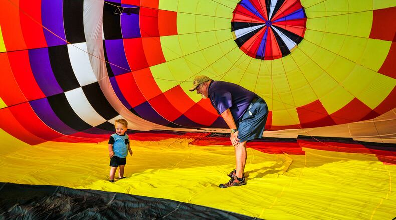 FILE PHOTO: Sean Askren stands with his grandson Asher Motley inside his hot air balloon "Bohica" as it is inflates during a media preview of a previous Ohio Challenge. The year's Ohio Challenge will be Friday and Saturday at Smith Park. NICK GRAHAM/STAFF