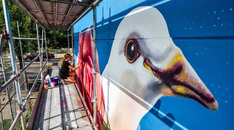 Sydnie Reatherford paints a section of the StreetSpark mural “Incrementum” Wednesday, July 3, 2019 on the side of the Max Stacy Flowers building on High Street in Hamilton. Design is by Paul M. Loehle and mural painted by artists Nicole Trimble, John McCoy, Sydnie Reatherford, Claire Talbot and Carrie Pate. NICK GRAHAM/STAFF