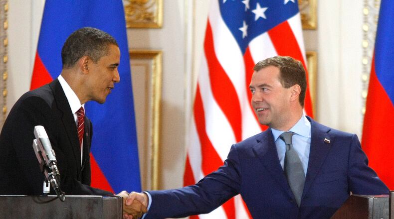 FILE - U.S. President Barack Obama, left, and his Russian counterpart Dmitry Medvedev, right, shake hands at a news conference at the Prague Castle in Prague, Czech Republic,, April 8, 2010, after signing the New START treaty reducing long-range nuclear weapons. (AP Photo/Mikhail Metzel, File)