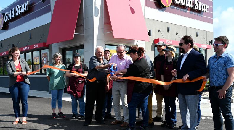 Gold Star CEO Roger David (center) celebrates with other the opening of the new westside Gold Star Chili restaurant on Friday, June 6, 2025. This store replaces the one on Main Street that was owned by franchisee Carlo Salem, who is retiring. This new store will be corporate-owned. The store had been opened since late May, and will offer a community celebration weekend in early August. MICHAEL D. PITMAN/STAFF