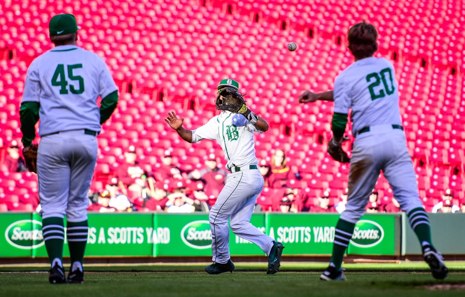 Badin’s Zac Wilson (20) tosses the ball to Daunte DeCello in the infield with pitcher Jarred Berger (45) at left during their game against Moeller on Friday at Great American Ball Park in Cincinnati. NICK GRAHAM/STAFF