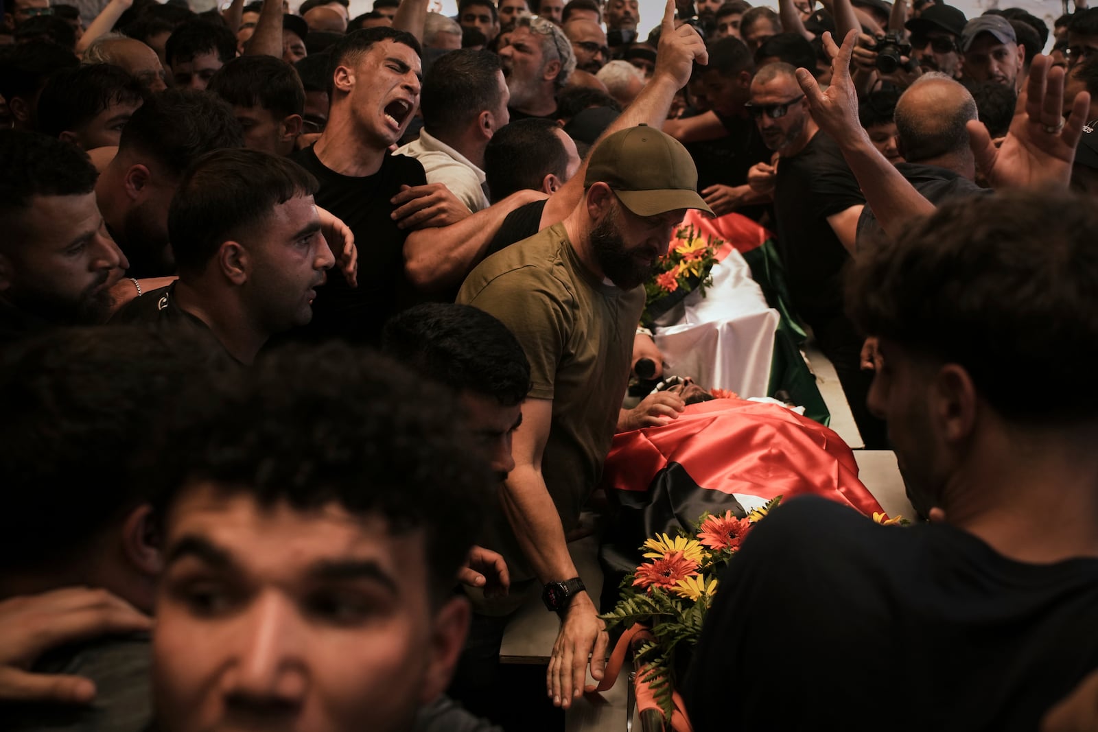 Mourners carry the bodies of Palestinian-American Sayfollah Musallet, 20, and Mohammed al-Shalabi during their funeral in the West Bank village of Al-Mazraa a-Sharqiya on Sunday, July 13, 2025. According to the Palestinian Health Ministry, Musallet was killed in an attack by Israeli settlers and al-Shalabi was shot in the chest. (AP Photo/Leo Correa)