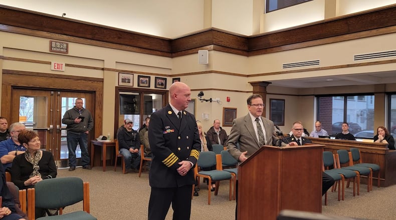 Monroe City Manager Bill Brock, right, talks about Dave Leverage, who was appointed fire chief during Tuesday's City Council meeting. Leverage replaced retiring Fire Chief John Centers. SUBMITTED PHOTO