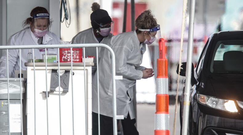 Nurses at Dayton Children's Hospital administer antigen test in their parking lot Dec. 8, 2020. The hospital stated that results are available in four hours or less “which can help speed up isolation of contagious individuals and contact tracing, in the hopes of slowing the spread of the virus in our community.” JIM NOELKER/STAFF