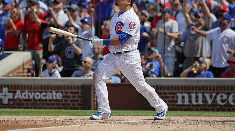 Kyle Schwarber, of the Chicago Cubs, follows the flight of his grand slam home run in the 7th inning against the St. Louis Cardinals at Wrigley Field on June 3, 2017. His contact was non-tendered and he signed a $10 million, one-year deal with the Washington Nationals (Photo by Jonathan Daniel/Getty Images)