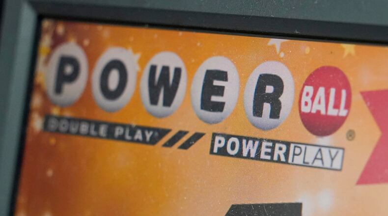 FILE - A display panel advertises tickets for a Powerball drawing at a convenience store, Nov. 7, 2022, in Renfrew, Pa. (AP Photo/Keith Srakocic, File)