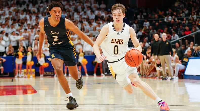 Centerville High School junior Gabe Cupps drives past Cleveland St. Ignatius' Carter Jackson during their game against Cleveland St. Ignatius on Saturday night at UD Arena. Michael Cooper/CONTRIBUTED