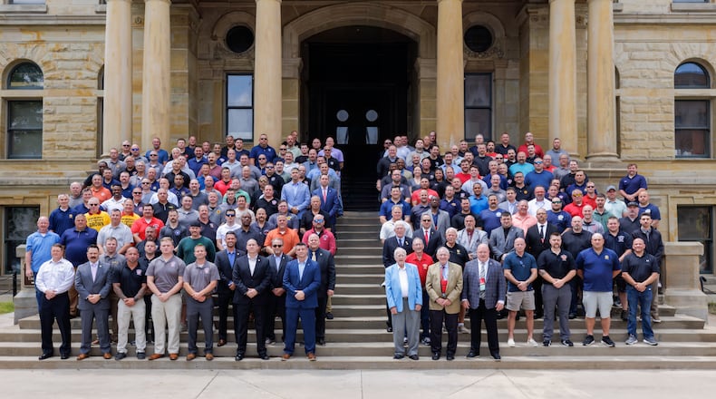 The firefighters recreated a photo on the steps of the Historic Butler County Courthouse during the Ohio Association of Professional Firefighters union membership conference held May 20-23 in Hamilton. TOM PATE/NARRATUS MEDIA