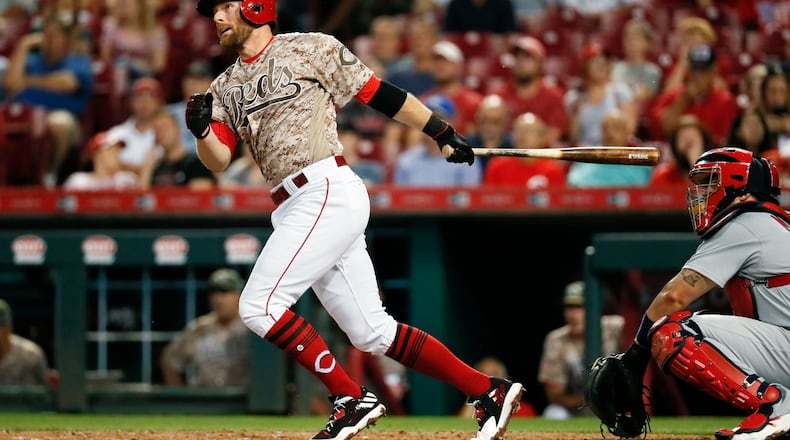 Cincinnati Reds’ Zack Cozart hits a two-run home run off St. Louis Cardinals relief pitcher John Gant in the third inning of a baseball game, Tuesday, Sept. 19, 2017, in Cincinnati. (AP Photo/John Minchillo)