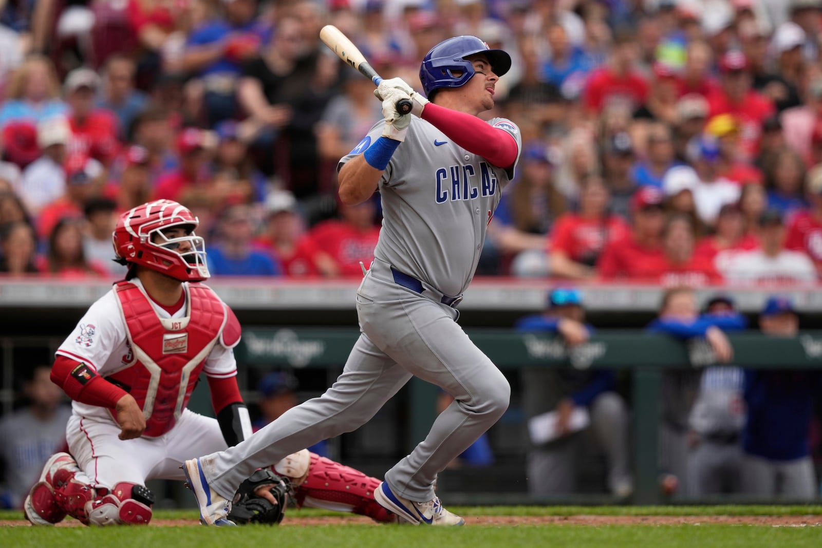 Chicago Cubs' Reese McGuire hits a solo home run as Cincinnati Reds catcher Jose Trevino looks on in the second inning of a baseball game, Sunday, May 25, 2025, in Cincinnati. (AP Photo/Carolyn Kaster)
