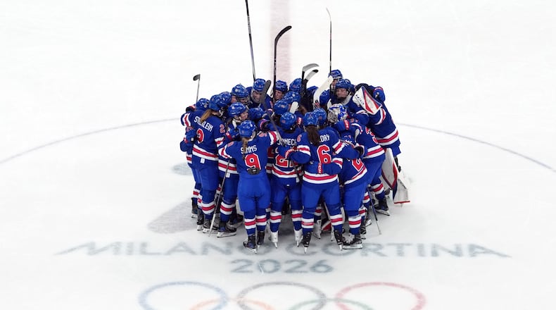 Team United States celebrates after their win over Sweden in a women's ice hockey semifinal match at the 2026 Winter Olympics, in Milan, Italy, Monday, Feb. 16, 2026. (AP Photo/Carolyn Kaster)