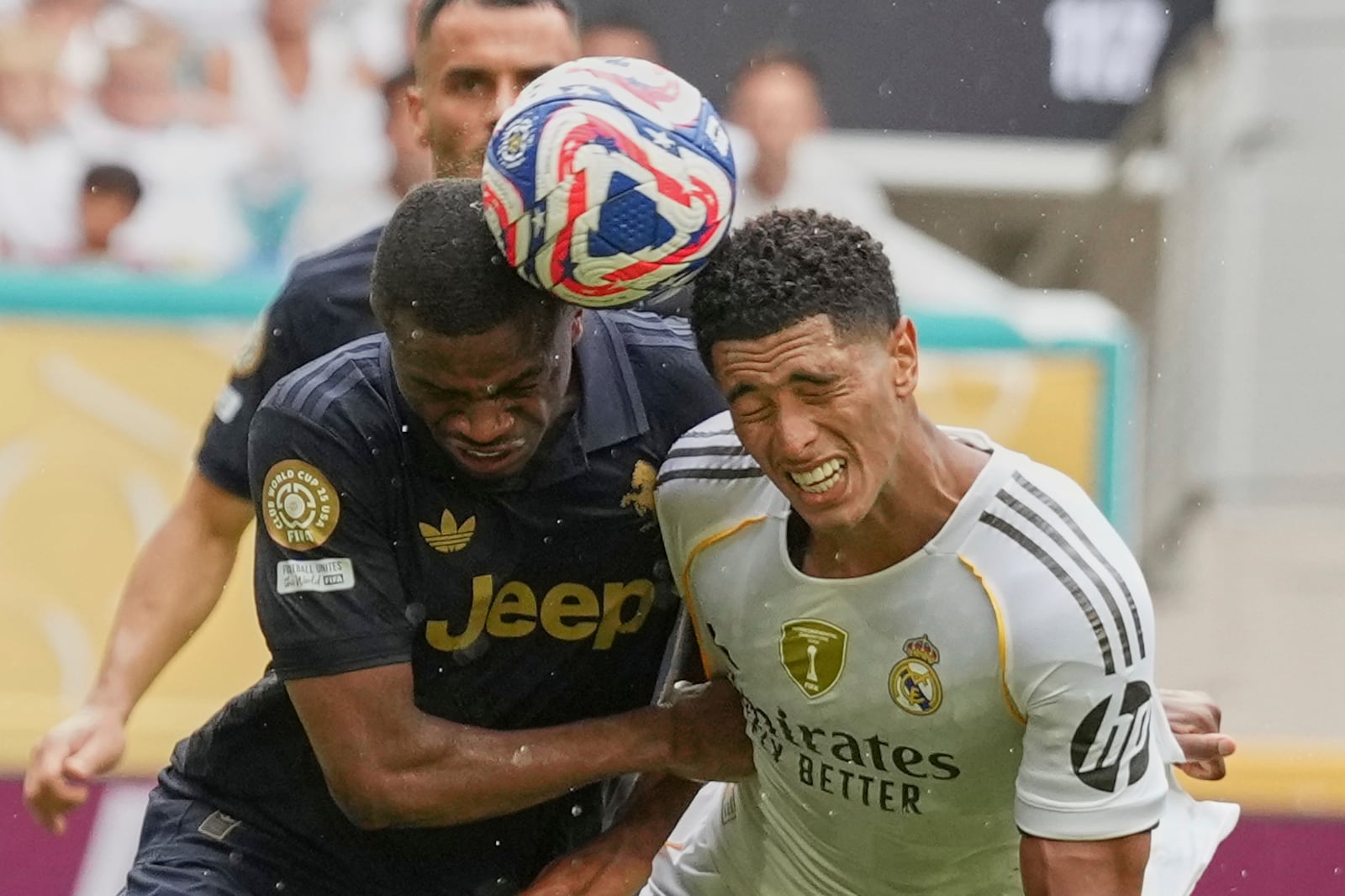 Juventus' Pierre Kalulu, left, and Real Madrid's Jude Bellingham go for the ball during the Club World Cup round of 16 soccer match between Real Madrid and Juventus in Miami Gardens, Fla., Tuesday, July 1, 2025. (AP Photo/Rebecca Blackwell)
