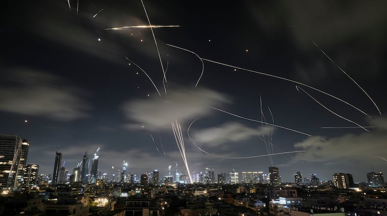 FILE - The Israeli Iron Dome air defense system intercepts missiles during an Iranian attack on Tel Aviv, Israel, June 18, 2025. (AP Photo/Leo Correa, File)