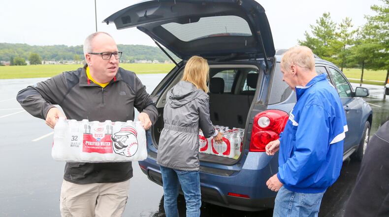 Jim Robishch, left, delivers water to Fairfield West Baptist Church, which partnered with Matthew 25: Ministries as a designated drop-off site to collect relief items for Houston and surrounding areas affected by flooding from Hurricane Harvey. Fenwick High School is collecting donations through Sept. 15 for Hurricane Harvey victims. GREG LYNCH/STAFF