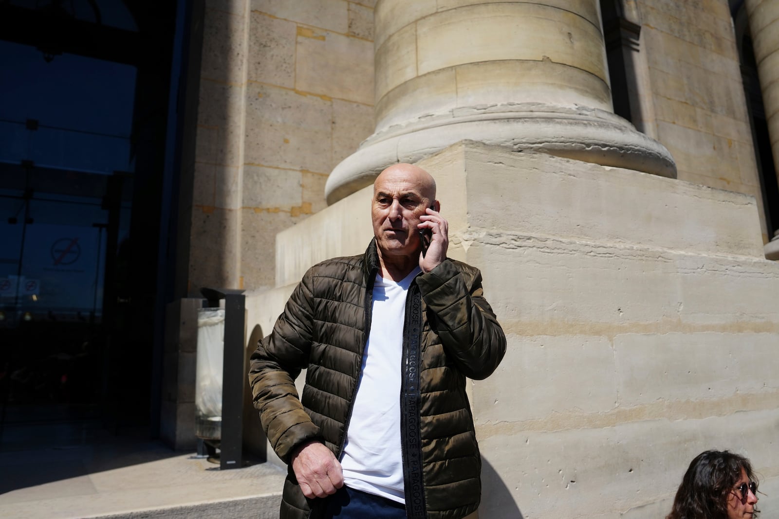 Yunice Abbas, one of the men accused in the 2016 armed robbery of Kim Kardashian, gives a phone call outside the palace of justice Monday, April 28, 2025 in Paris. (AP Photo/Aurelien Morissard)