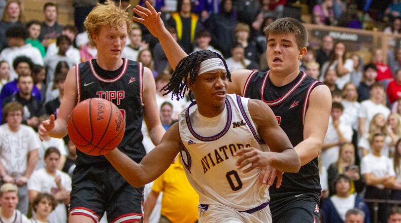 Butler's Jon-Fayne Cunningham passes from the baseline as he is guarded by Tippecanoe's Jackson Smith, who did a little bit of everything for the Red Devils and scored 20 points. Jeff Gilbert/CONGTRIBUTED