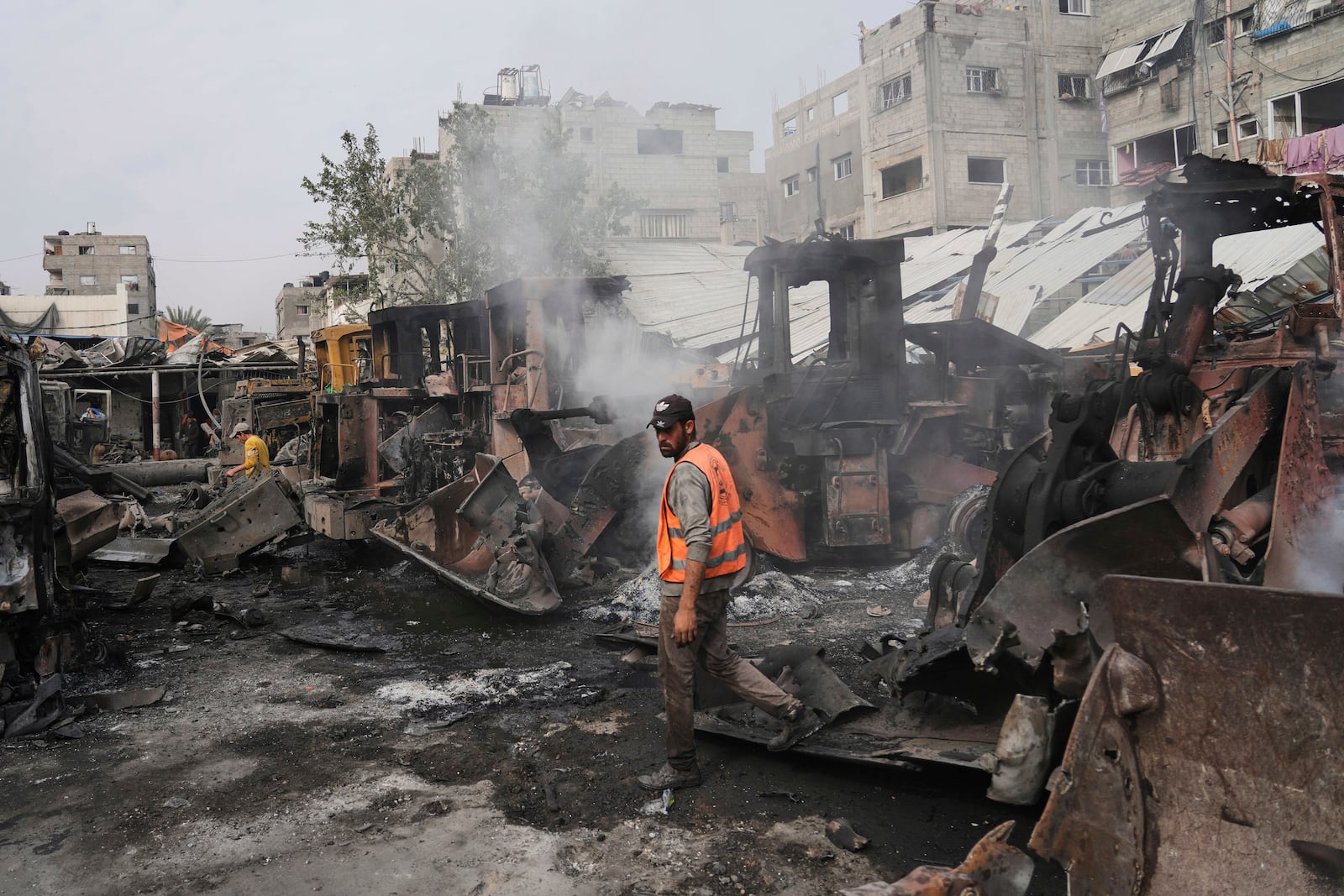 Palestinians examine the remains of bulldozers hit by an Israeli army airstrike in Jabaliya, northern Gaza Strip, on Tuesday, April 22, 2025. (AP Photo/Jehad Alshrafi)