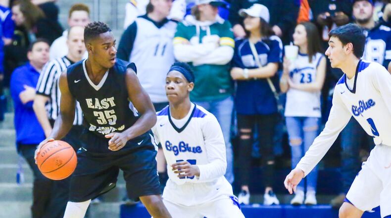 Lakota East guard Jarrett Cox (35) surveys the Hamilton defense during their game at the Hamilton Athletic Center on Feb. 10. GREG LYNCH/STAFF