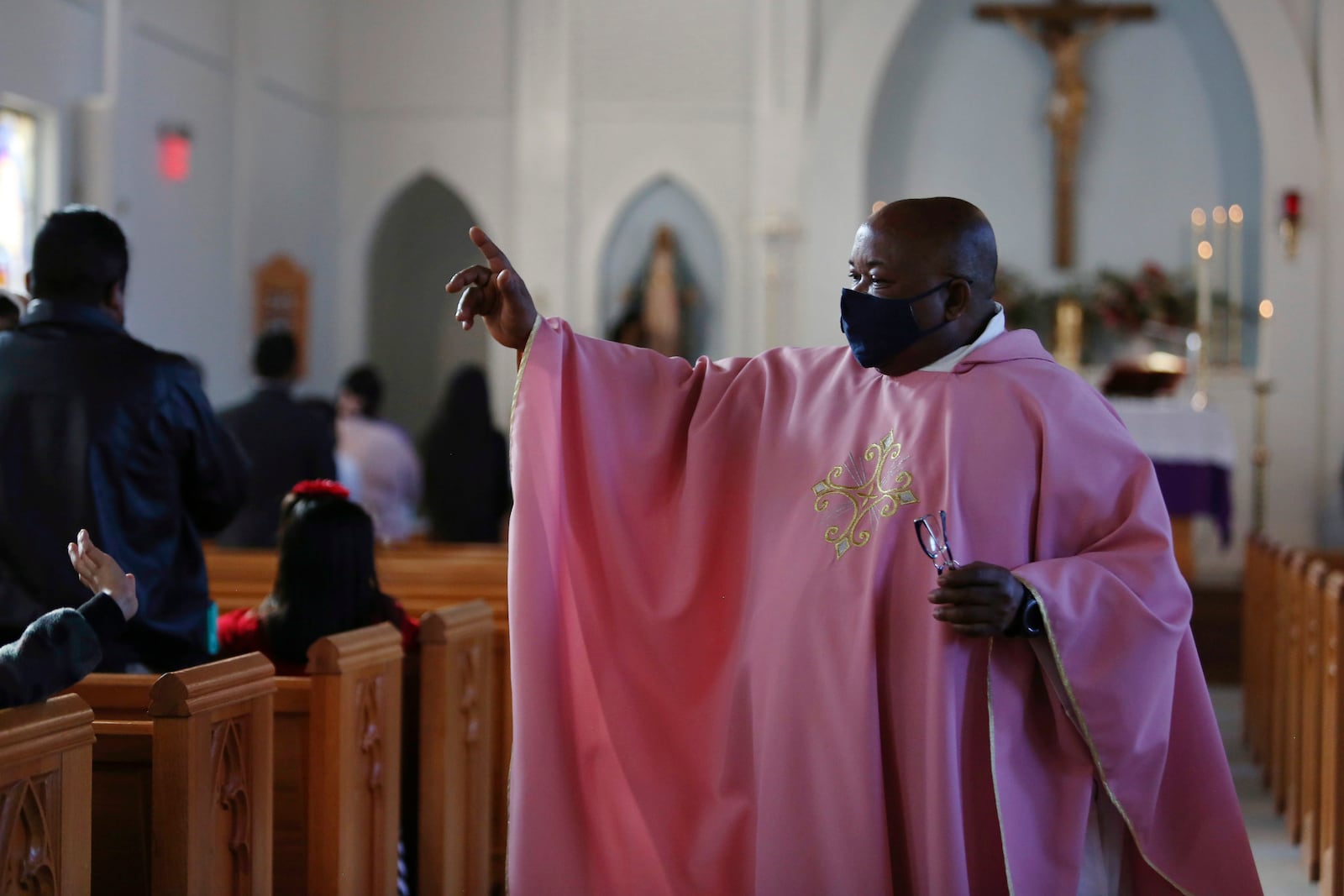 FILE - The Rev. Athanasius Abanulo waves to his parishioners after Mass on Dec. 12, 2021, at Immaculate Conception Catholic Church in Wedowee, Ala. (AP Photo/Jessie Wardarski, File)
