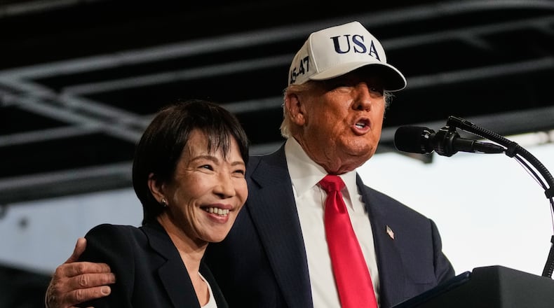 President Donald Trump, with Japanese Prime Minister Sanae Takaichi, speaks to members of the military aboard the USS George Washington, an aircraft carrier docked at an American naval base, in Yokosuka, Tuesday, Oct. 28, 2025. (AP Photo/Mark Schiefelbein)