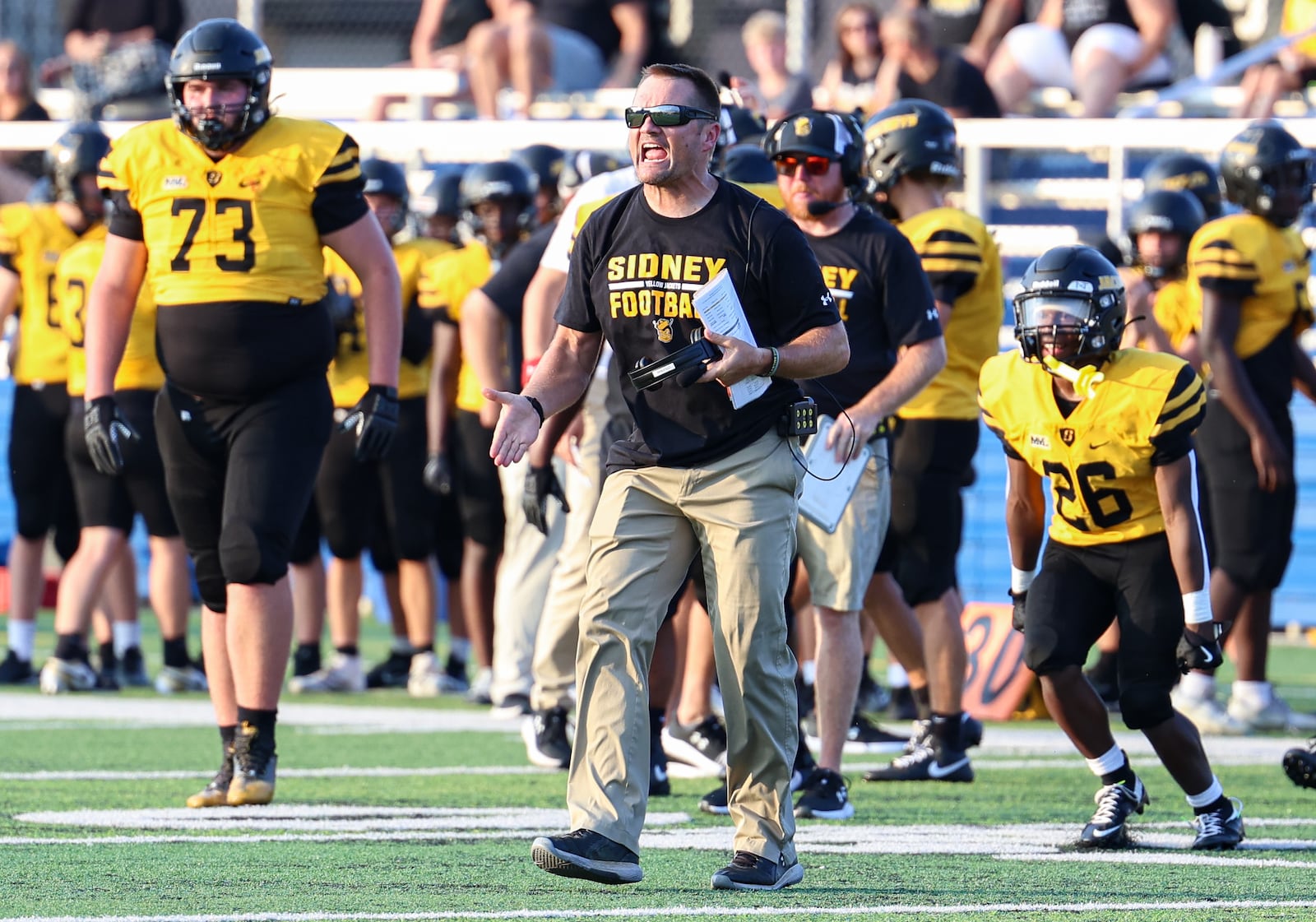 Sidney High School football coach Kyle Coleman talks to players during their scrimmage at Chaminade-Julienne on Friday, Aug. 15 at Roger Glass Stadium. BRYANT BILLING / STAFF