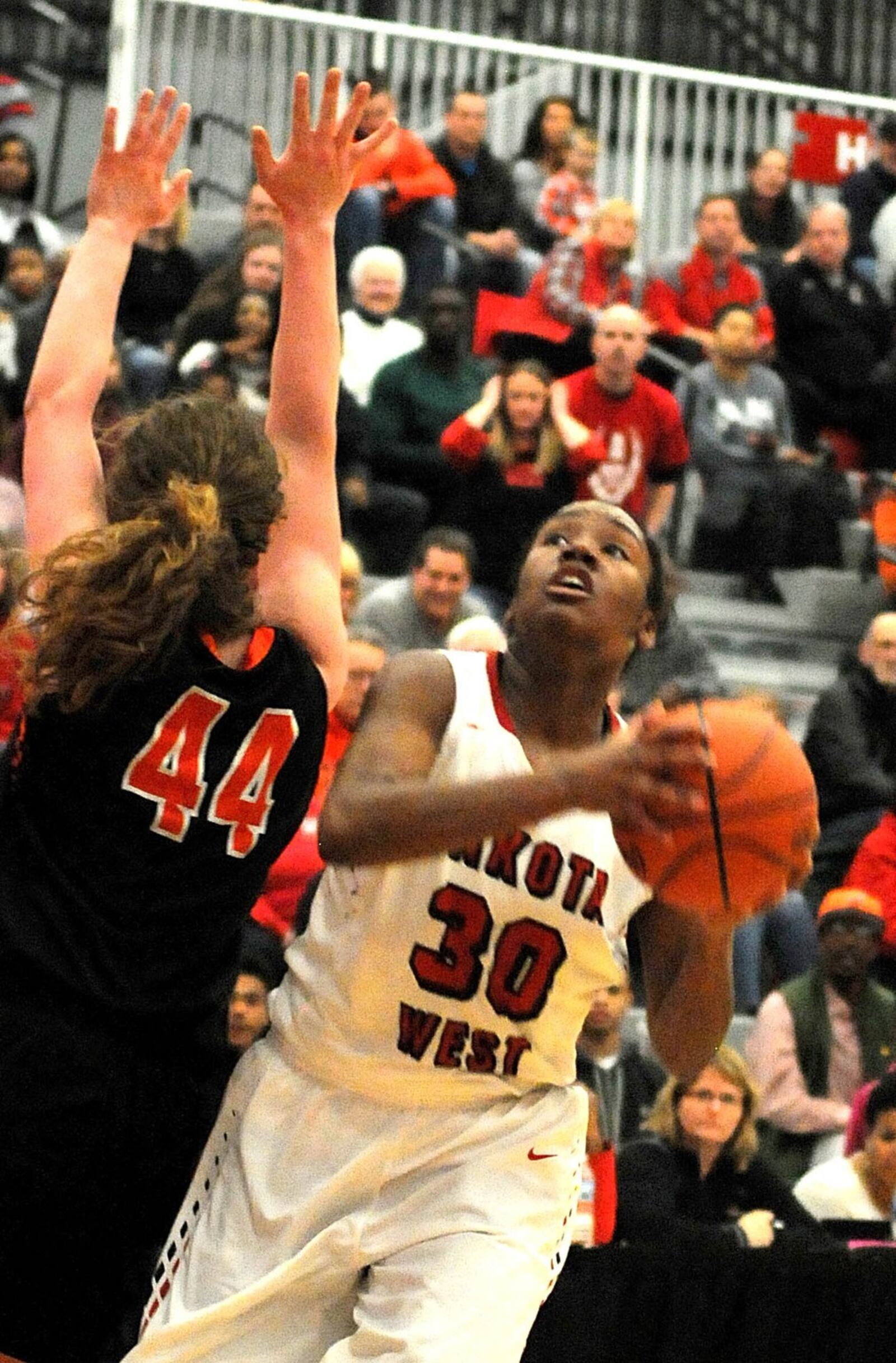 Lakota West’s Jasmine Ballew (30) sets up to take a shot against Beavercreek’s Lexi Moore (44) during Saturday’s Division I district final at Princeton. CONTRIBUTED PHOTO BY DAVID A. MOODIE