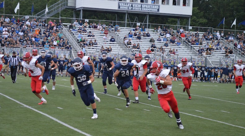 Madison’s Cameron Svarda (26) gets past Valley View’s Jonny Jones (30) and Jackson Lang (24) during a 24-16 road win Sept. 7 at Barker Field in Germantown. CONTRIBUTED PHOTO BY ERIC FRANTZ
